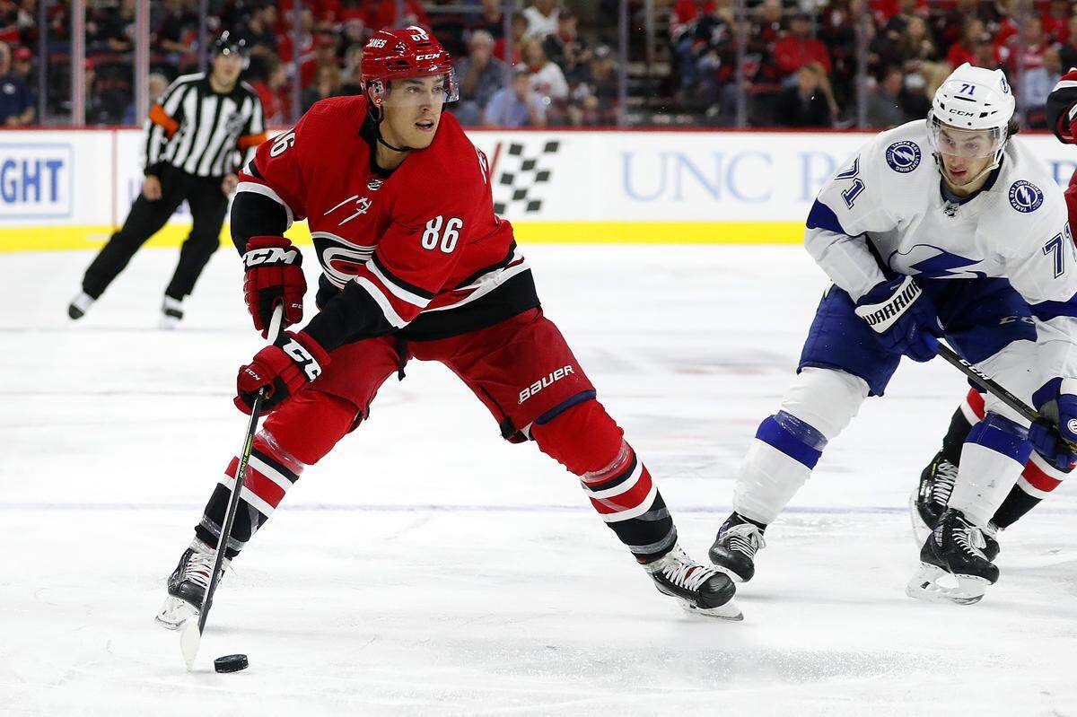 Carolina Hurricanes’ Teuvo Teravainen (86) moves the puck against the Tampa Bay Lightning during the second period of an NHL hockey game, in Raleigh, N.C., Sunday, Oct. 6, 2019.