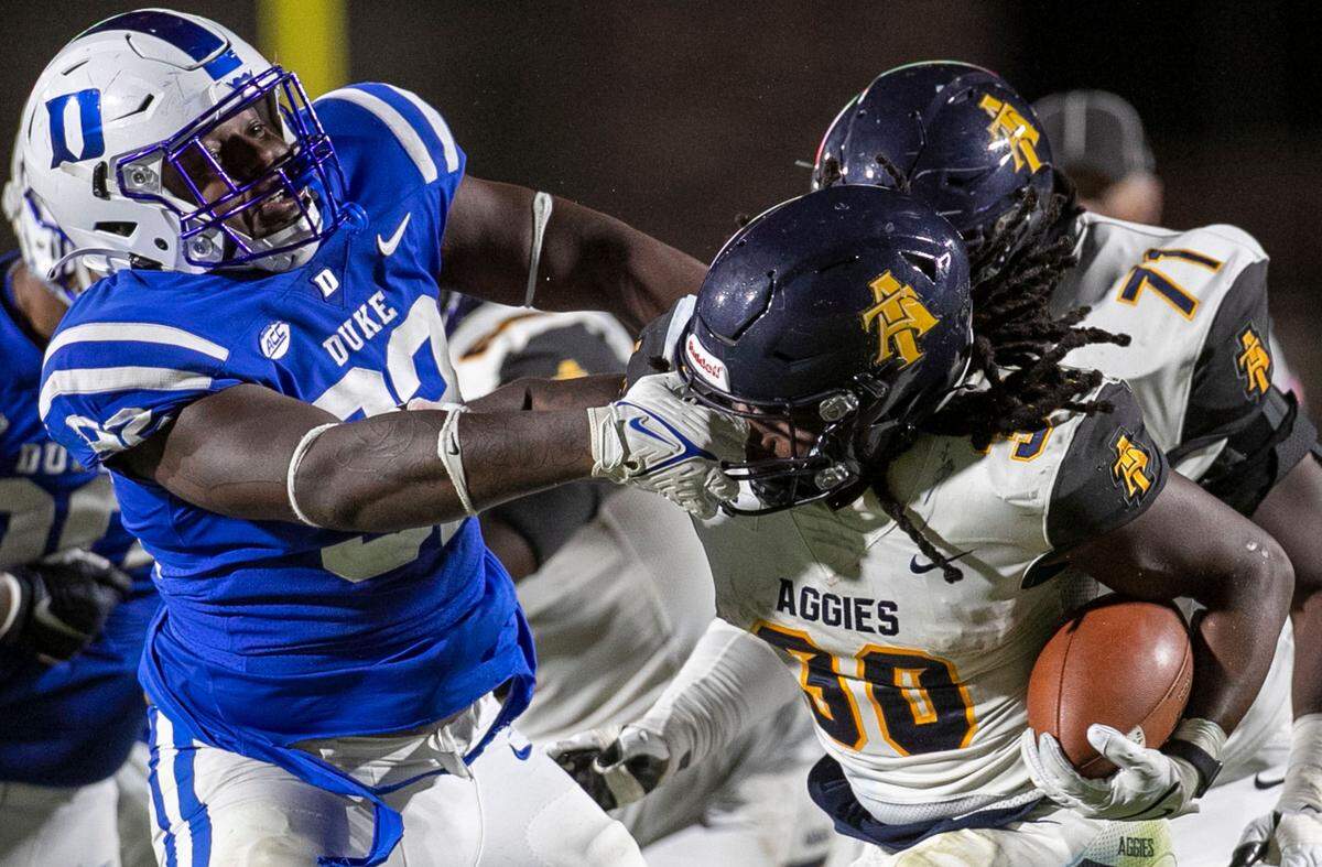 Duke’s Aeneas Peebles (92) grabs the face mask of North Carolina A&T’s Jah-Maine Martin (30) in the third quarter on Friday, September 10, 2021 at Wallace Wade Stadium in Durham, N.C.