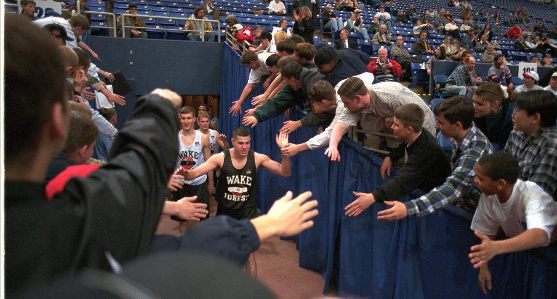 3/21/96 1B: FOR PUBLISHED CUTLINE / CAPTION, SEE VUTEXT SAVE. **UNPUBLISHED NOTES : ** (3/20/96 LAYE)Wake Forest’s Rusty LaRue is swarmed by fans as he runs onto the court at the HHH Metrodome in Minneapolis Wednesday for practice for the NCAA Regional. Christopher A. Record/Staff