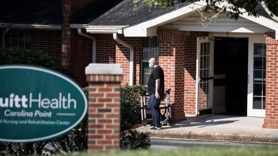 A staff member of PruittHealth-Carolina Point walks out of the nursing home and rehabilitation center on Thursday, April 9, 2020. It is one of two long-term care facilities with coronavirus outbreaks in Orange County, according to the county health department. Gov. Roy Cooper announced on Wednesday that at least 60 people at this facility, both patients and staff members, have tested positive for COVID-19. Seven of those are at Duke University Hospital, and two have died.