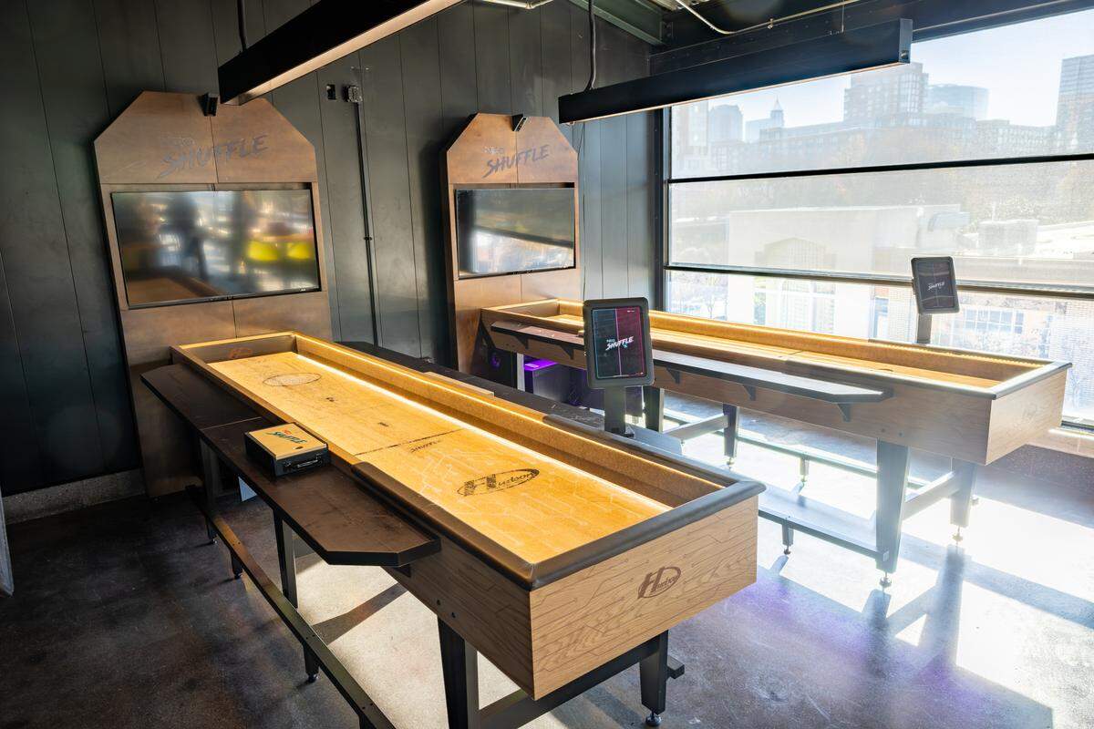 Digital shuffleboard is one of the games guests can reserve and play at Smash Social Club.