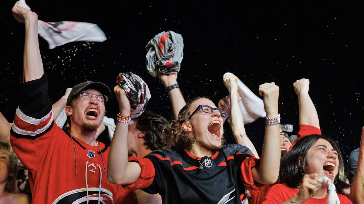 Fans react at a watch party outside the Lenovo Center after the Hurricanes scored to take a 2-0 lead over the Vegas Golden Knights during game six of the Stanley Cup Final on Sunday, June 14, 2026, in Raleigh, N.C.