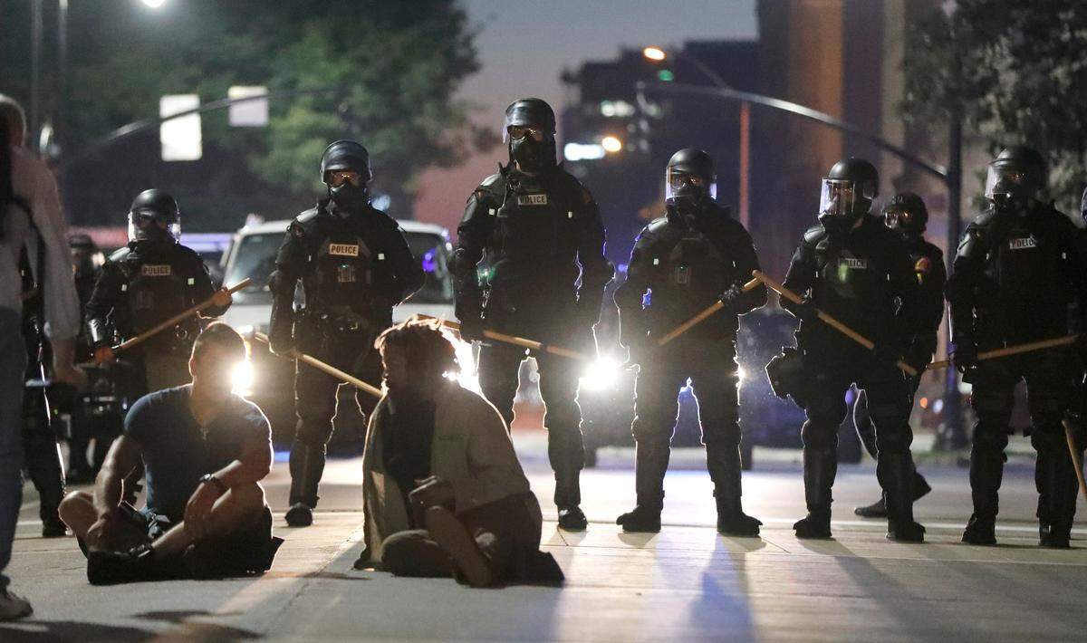 Police in riot gear form a line on Morgan Street by the North Carolina State Capital during a protest in downtown Raleigh, N.C., Sunday, May 31, 2020.