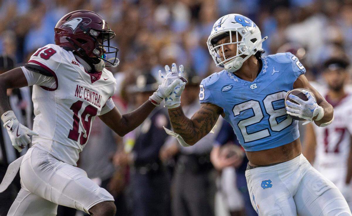 North Carolina running back Omarion Hampton (28) stiff arms N.C. Central defensive back Jaylen Bowden (19) on a 53-yard run in the second quarter on Saturday, September 14, 2024 at Kenan Stadium in Chapel Hill, N.C.