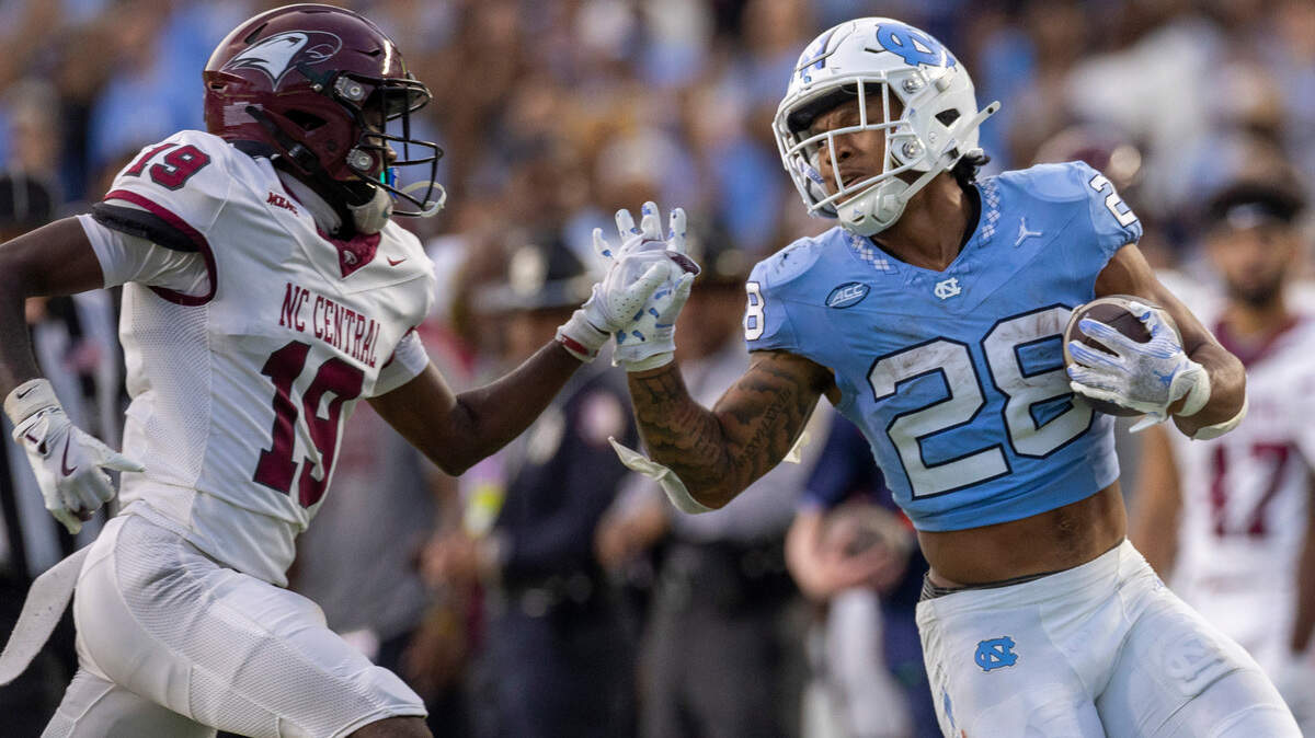 North Carolina running back Omarion Hampton (28) stiff arms N.C. Central defensive back Jaylen Bowden (19) on a 53-yard run in the second quarter on Saturday, September 14, 2024 at Kenan Stadium in Chapel Hill, N.C.