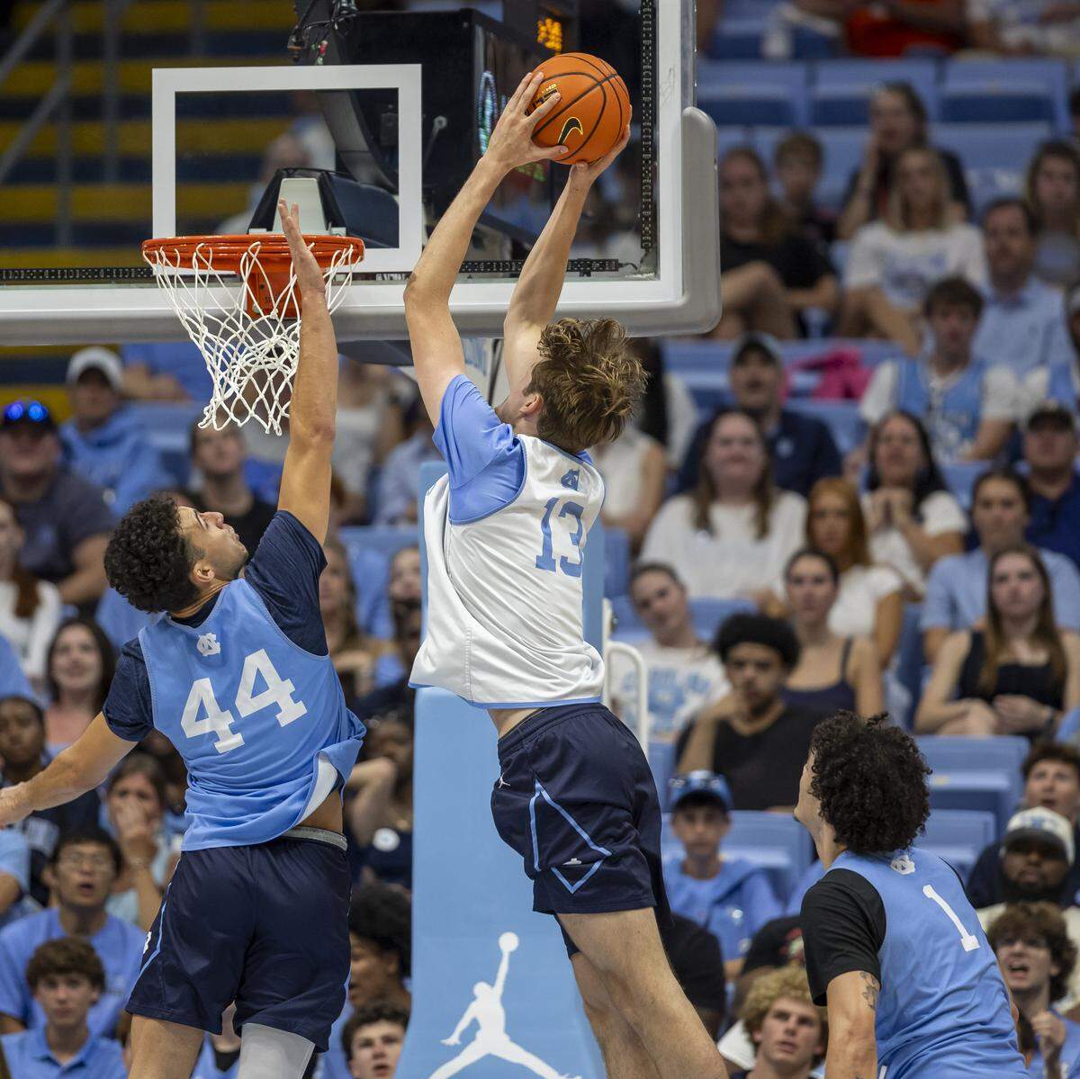 North Carolina center Henri Veesaar (13) breaks to the basket for a dunk against North Carolina guard Luka Bogavac (44) during the Blue-White scrimmage on Saturday, October 4, 2025 at the Smith Center in Chapel Hill, N.C.