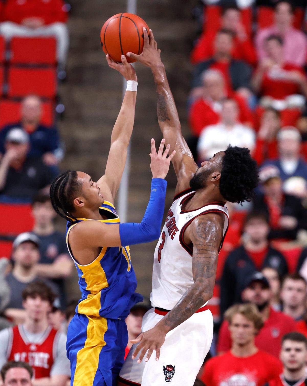 N.C. State’s Dontrez Styles (3) blocks the shot by Pittsburgh’s Jaland Lowe (15) during the first half of N.C. State’s game against Pitt at the Lenovo Center in Raleigh, N.C., Wednesday, March 5, 2025.