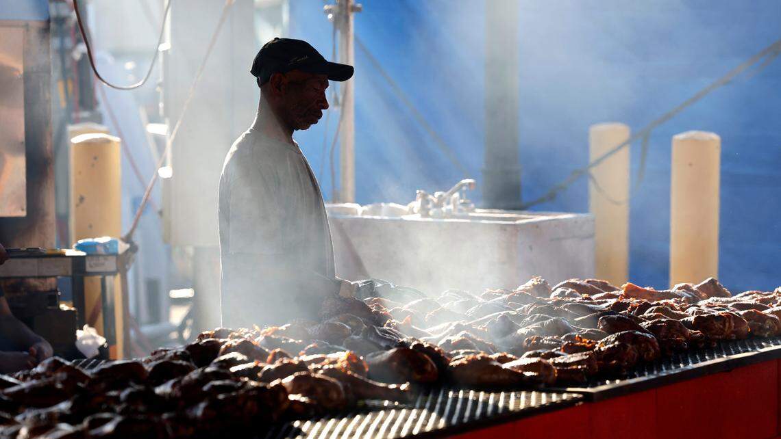Ricky Hinton cooks turkey legs at McBride’s Giant Turkey Legs tent at the N.C. State Fair in Raleigh, N.C., Thursday, Oct. 12, 2023.