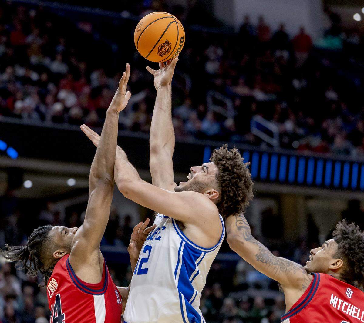 Duke forward Cameron Boozer (12) puts up a shot against St. John’s forwards Zuby Ejiofor (24) and Dillon Mitchell (1) in the first half during the Sweet Sixteen of the NCAA Tournament on Friday, March 27, 2026, at Capital One Arena in Washington, D.C.