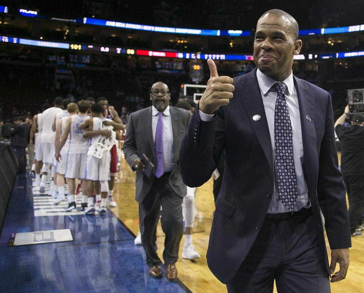 North Carolina assistant coach Hubert Davis gives a thumbs up to fans as he leaves the court following the 101-86 victory over Indiana on Friday, March 25, 2016 in the NCAA East Regional semi-finals at the Wells Fargo Center in Philadelphia, Pa.