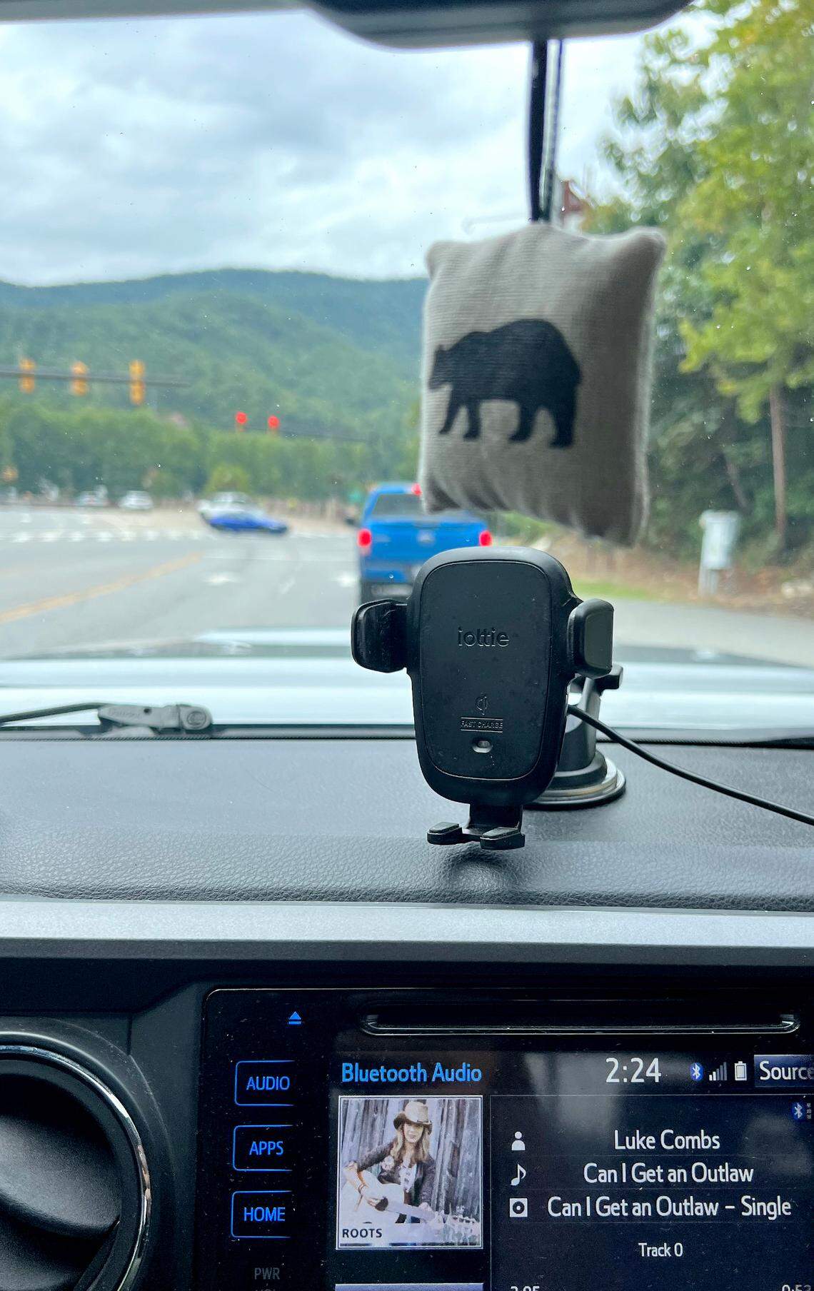 A souvenir pillow filled with Fraser fir needles purchased at the Mount Mitchell State Park gift shop hangs from a rearview mirror.