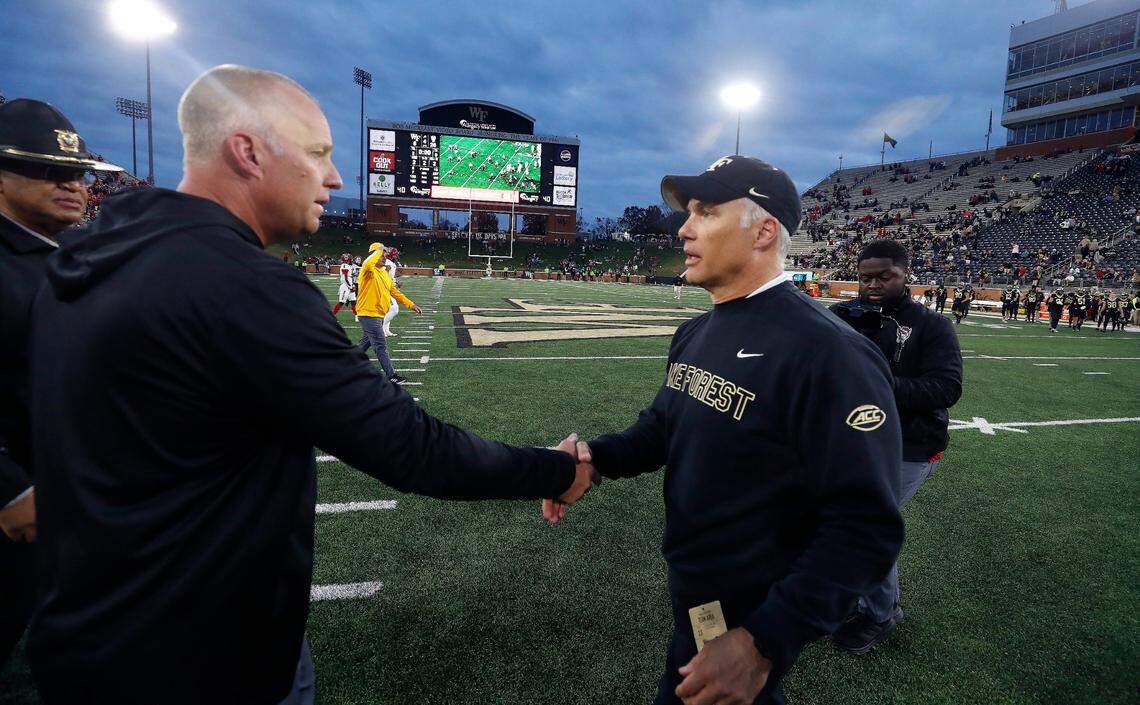 N.C. State head coach Dave Doeren greets Wake Forest head coach Dave Clawson after N.C. State’s 26-6 victory over Wake Forest at Allegacy Stadium in Winston-Salem, N.C., Saturday, Nov. 11, 2023.