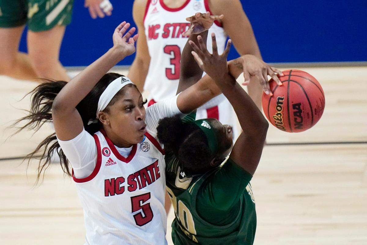 North Carolina State forward Jada Boyd (5) blocks a shot by South Florida forward Bethy Mununga (20) during the second half of a college basketball game in the second round of the women’s NCAA tournament at the Alamodome in San Antonio, Tuesday, March 23, 2021. 