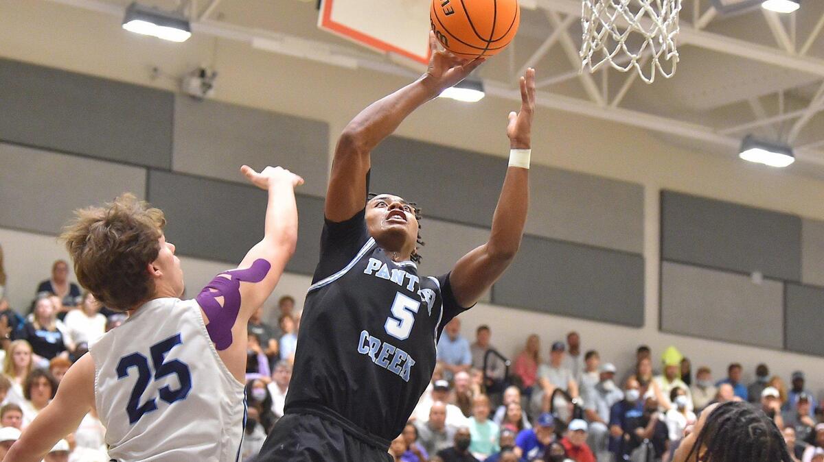 Panther Creek’s Tyler Thompson (5) shoots against Cleveland’s Dylan Smith (25) in the first half. The Panther Creek Catamounts and the Cleveland Rams met in the NCHSAA 4A Boys East Regional Finals in Cary, N.C. on March 5, 2022.