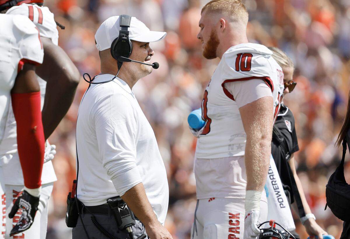 N.C. State defensive coordinator Tony Gibson talks with linebacker Caden Fordham (10) during the first half of N.C. State’s game against Clemson at Memorial Stadium in Clemson, S.C., Saturday, Sept. 21, 2024.
