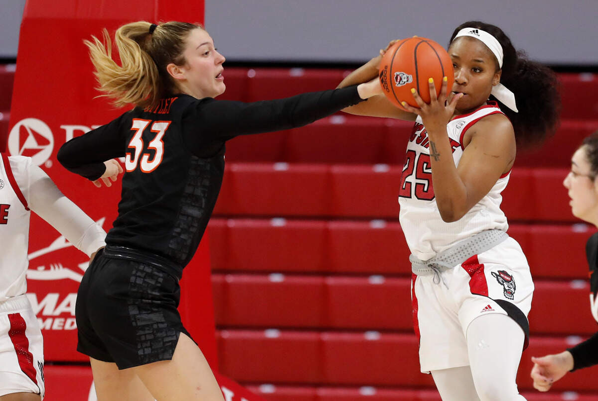 N.C. State’s Kayla Jones (25) pulls in a rebound from Virginia Tech’s Elizabeth Kitley (33) during the second half of N.C. State’s 89-87 victory over Virginia Tech at Reynolds Coliseum in Raleigh, N.C., Sunday, January 24, 2021.