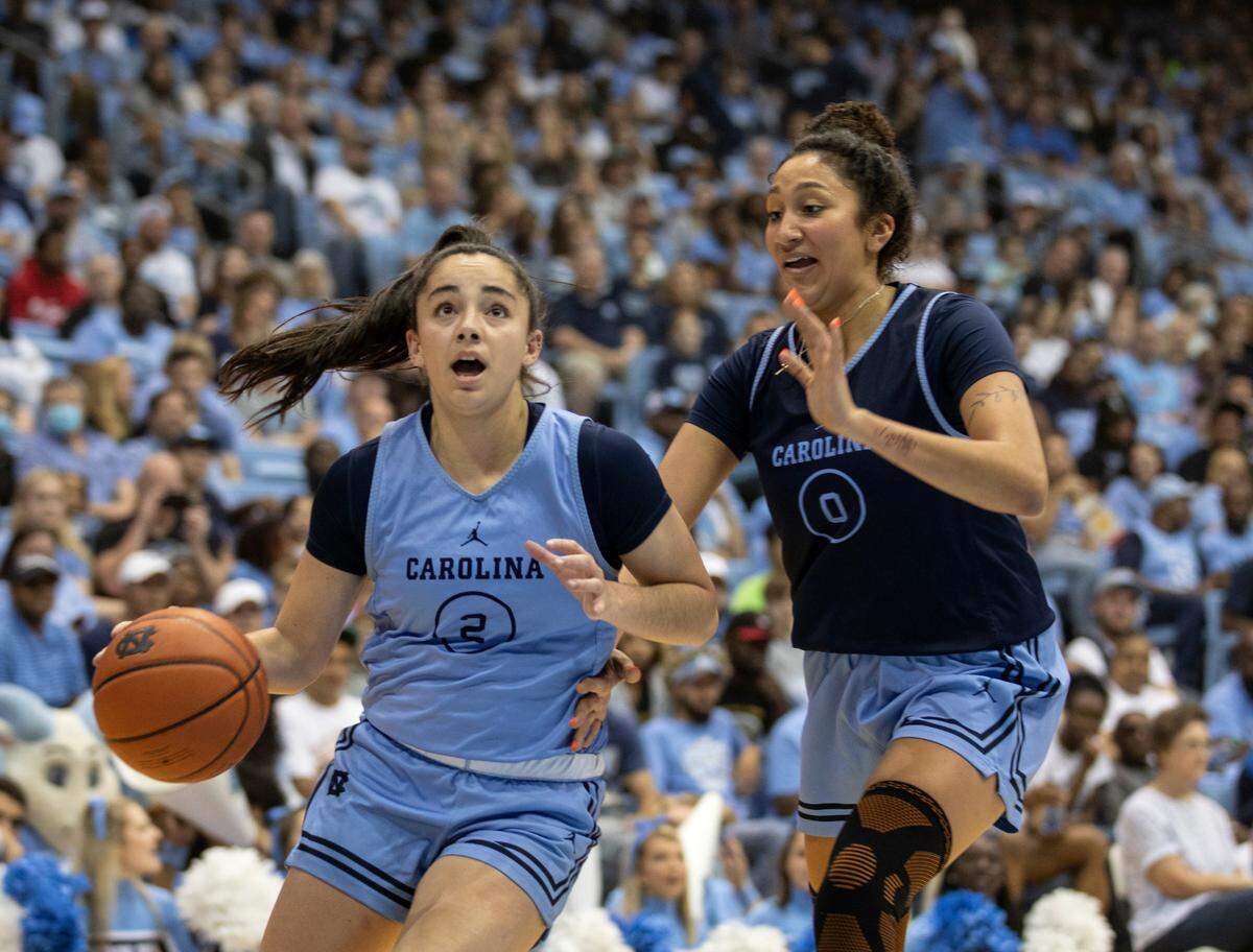 Paulina Paris drives by Alexandra Zelaya during a scrimmage at “Live Action with Carolina Basketball” at the Dean E. Smith Center on Friday, Oct. 7, 2022, in Chapel Hill, N.C.