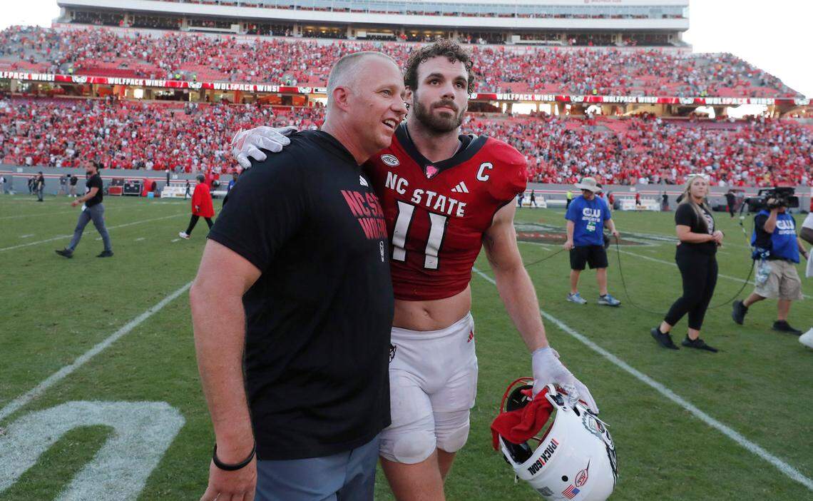 N.C. State head coach Dave Doeren and Payton Wilson (11) talk with each other after the Wolfpack’s 24-17 victory over Clemson at Carter-Finley Stadium in Raleigh, N.C., Saturday, Oct. 28, 2023.