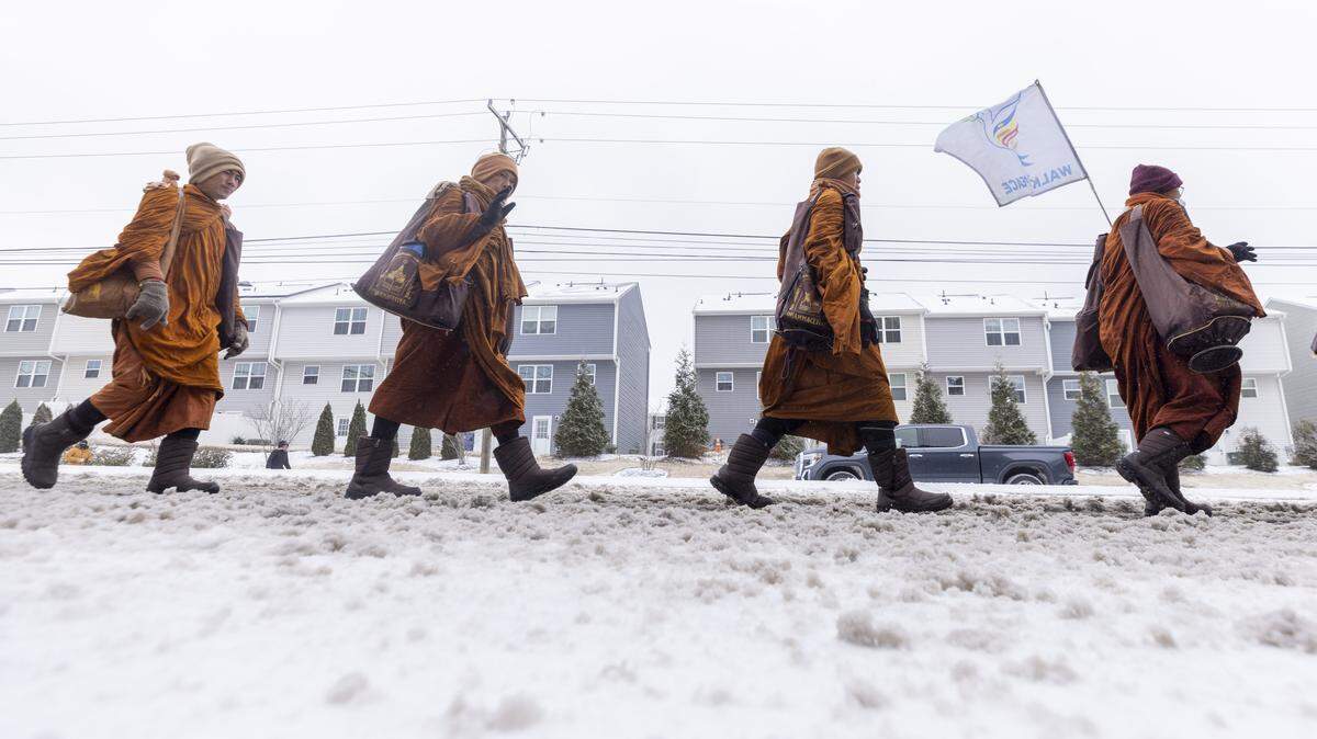 Despite winter weather conditions, a procession of Buddhist monks walks along Buffaloe Road on Sunday, Jan. 25, 2026, in Raleigh. The monks are making a 2,300-mile pilgrimage from Texas to Washington, D.C., as part of the Walk for Peace, an effort to promote peace, compassion and national unity.