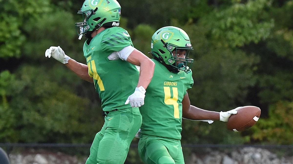 Cardinal Gibbons’ Landon Lawrence (4) celebrates with Chet Yardley (14) after making the touchdown in the first half. The Cardinal Gibbons Crusaders and the Richmond Raiders met in a football game in Raleigh, N.C. on September 2, 2022.