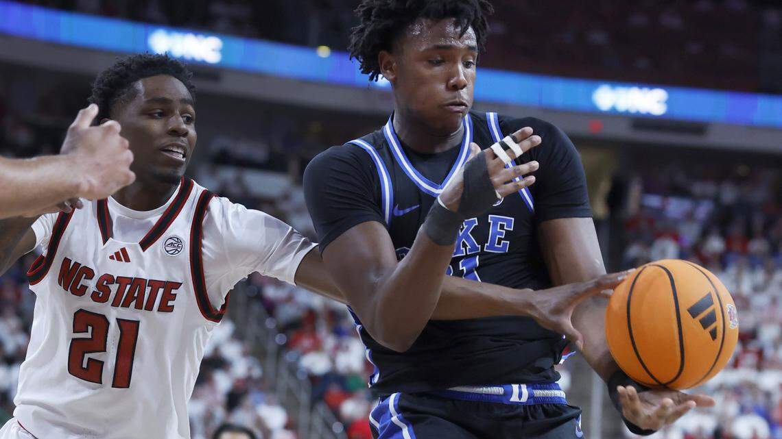 NC State's Terrance Arceneaux (21) and Duke’s Patrick Ngongba II (21) go after the ball during the first half of Duke’s game against N.C. State at the Lenovo Center in Raleigh, N.C., Monday, March 2, 2026.