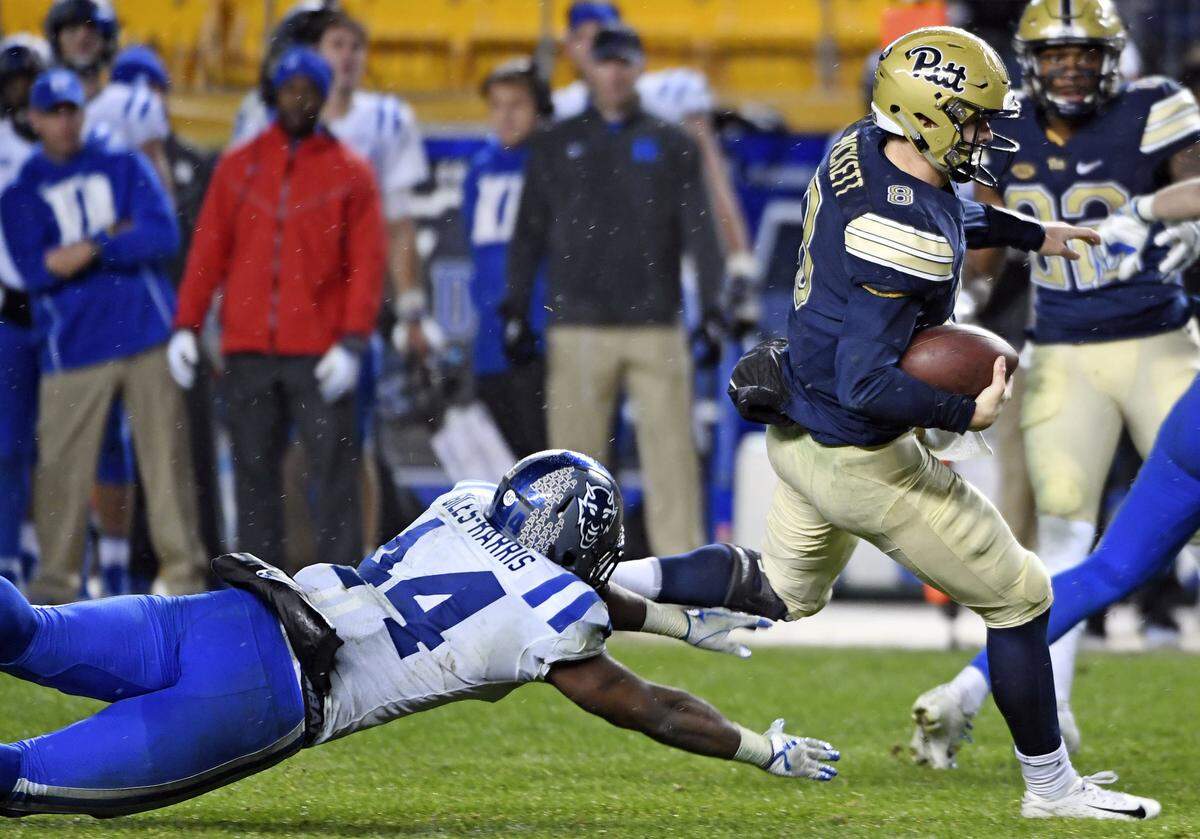 Pittsburgh’s Kenny Pickett (8) avoids Duke’s Joe Giles-Harris (44) in the fourth quarter of an NCAA college football game, Saturday, Oct. 27, 2018, in Pittsburgh. Pitt won 54-45. 