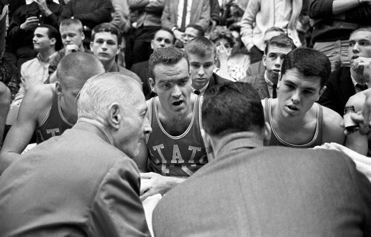 N.C. State coach Everett Case instructs his players during the Wolfpack’s game against Duke in 1963.