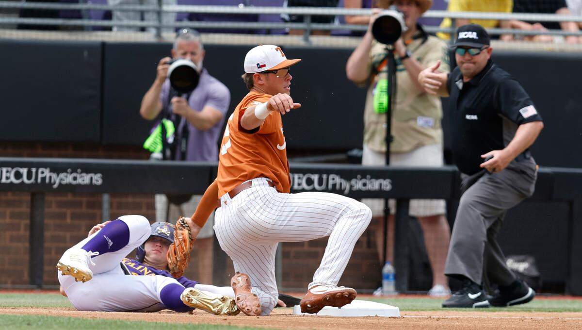 Texas’ Skyler Messinger (5) picks off East Carolina’s Lane Hoover (4) in the first inning during ECU’s game against Texas in the Greenville Super Regional at Clark-LeClair Stadium Saturday, June 11, 2022.