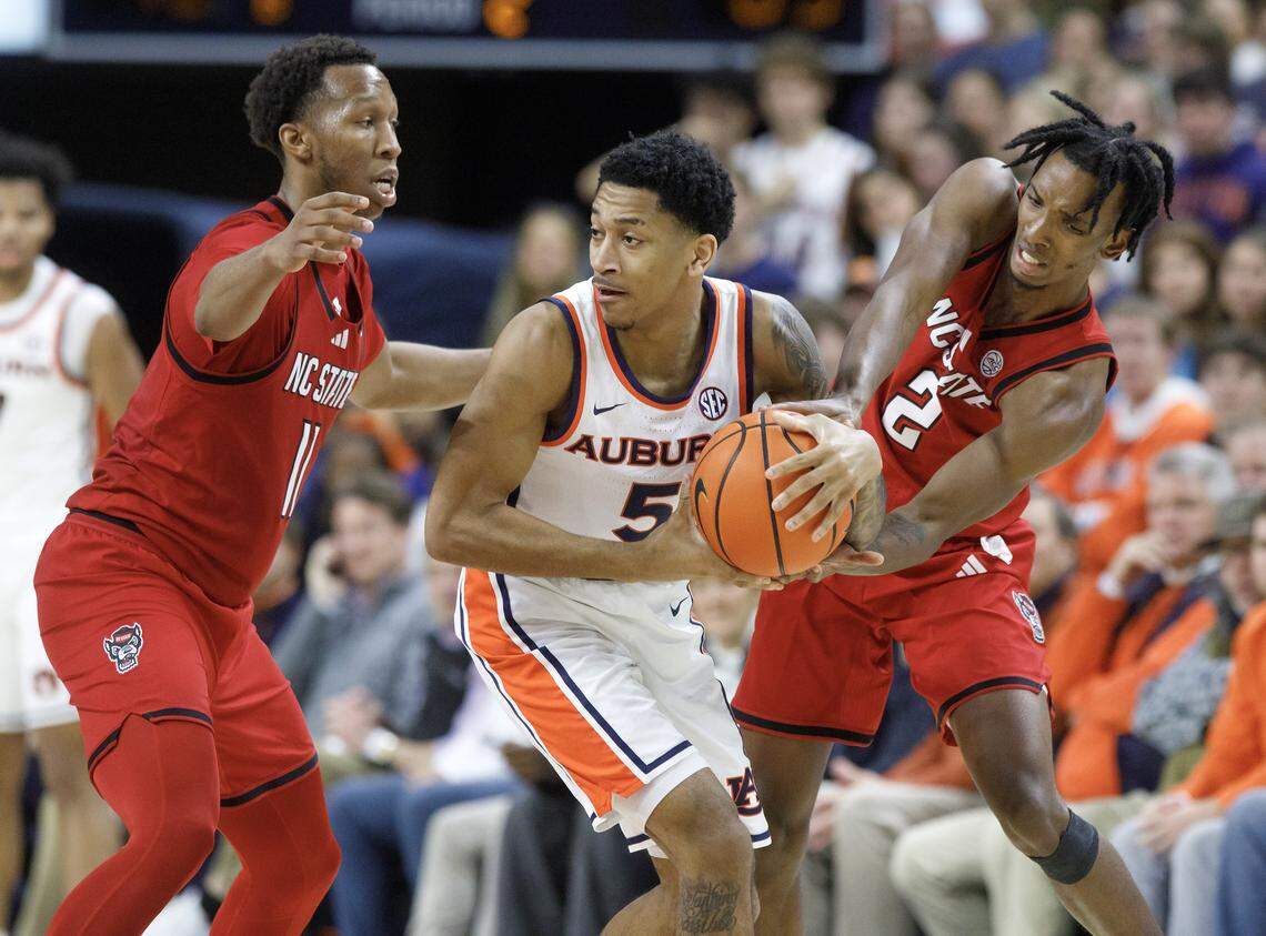 N.C. State’s Quadir Copeland and Paul McNeil pressure Auburn’s Kaden Magwood during the second half of the Wolfpack’s 83-73 loss in the ACC/SEC Challenge on Wednesday, Dec. 3, 2025, at Neville Arena in Auburn, Ala. 
