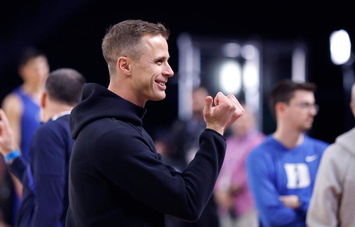 Duke head coach Jon Scheyer responds to fans with the Bull City hand gesture during Duke’s practice at the Alamodome in San Antonio, Texas, Friday, April 4, 2025.