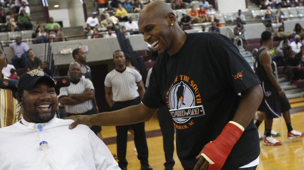 Former UNC star Jerry Stackhouse, right, greets former Wake Forest star Rodney Rogers on Sunday. TAKAAKI IWABU - tiwabu@newsobserver.com