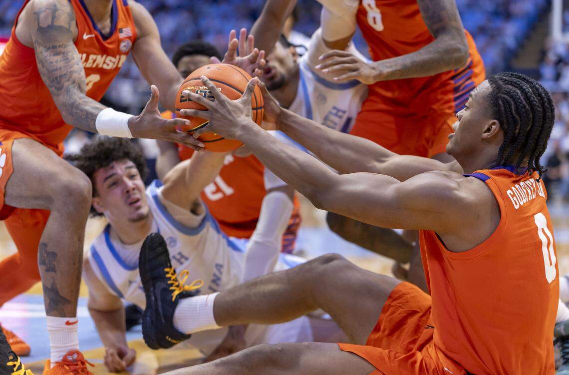 Clemson forward R J Godfrey (0) recovers the ball after a floor scramble with North Carolina forward Zayden High (1) and teammates Dillon Hunter (2) and Dallas Thomas (8) in the first half on Tuesday, March 3, 2026 at the Smith Center in Chapel Hill, N.C.