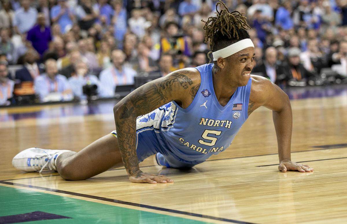 North Carolina’s Armando Bacot grimaces in pain after injuring his ankle late in the second half against Kansas in the NCAA Championship game on Monday, April 4, 2022 at Caesars Superdome in New Orleans, La.