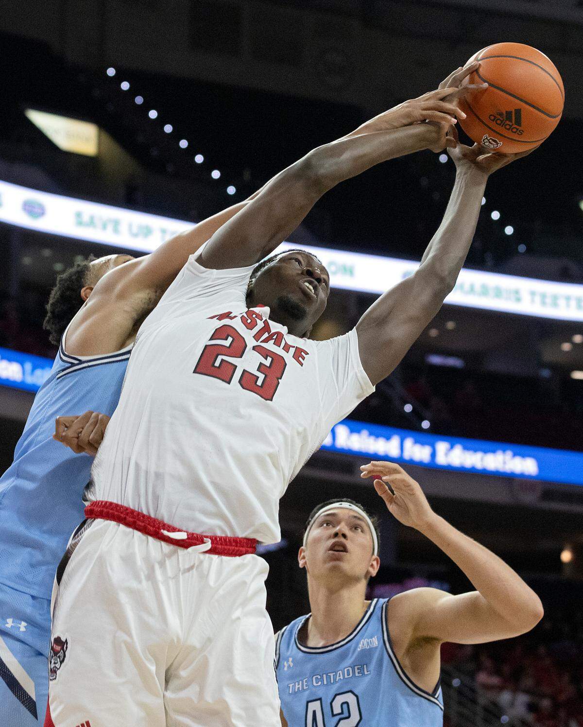 N.C. State’s Mohamed Diarra grabs a rebound away from The Citadel’s Winston Hill and Quentin Millora-Brown during the second half of the Wolfpack’s 72-59 win on Monday, Nov. 6, 2023, at PNC Arena in Raleigh, N.C.