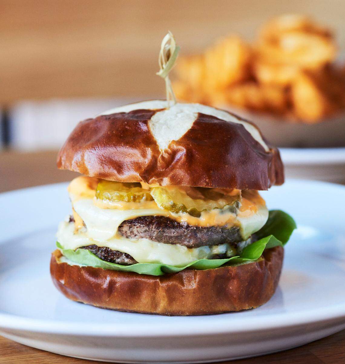 One of the most famous items at Emmy Squared is a double cheeseburger served on a pretzel bun.