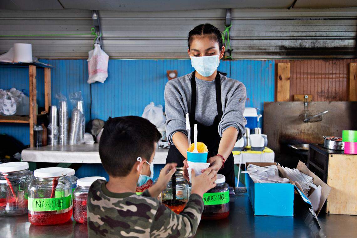 An employee at the Las Delicias De Magdalena booth, who asked not to be identified, serves a customer at the Durham Green Flea Market on Saturday, Sept. 18, 2021. North Carolina’s fast growth and increasing political influence is largely due to Hispanic people, who made up a massive chunk of the state’s growth from 2010 to 2020.
