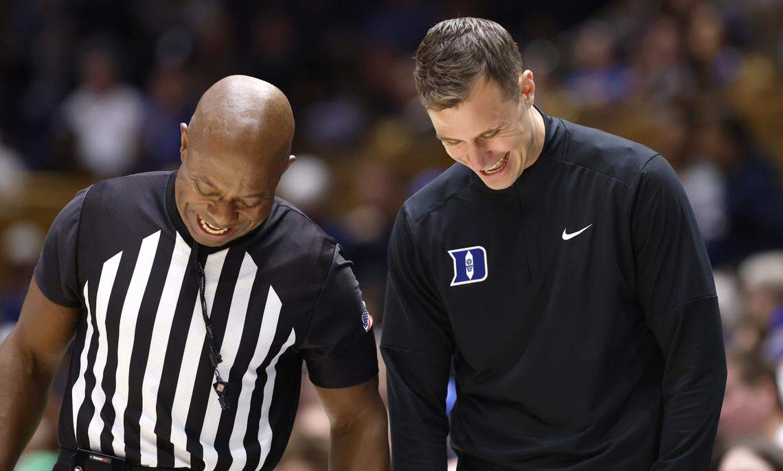 Duke’s head coach Jon Scheyer laughs with official Clarence Armstrong during the second half of Duke’s 93-56 victory over Howard at Cameron Indoor Stadium in Durham, N.C., Sunday, Nov. 23, 2025.