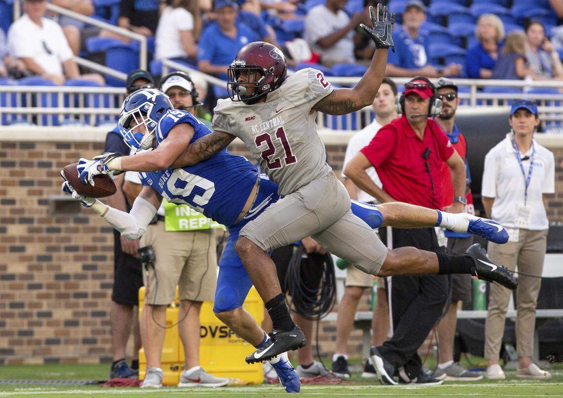Duke’s Jake Bobo, left, makes a diving catch ahead of N.C. Central’s Daryl Smith, right, during the second half of the Blue Devils’ 55-13 win over the Eagles on Saturay.