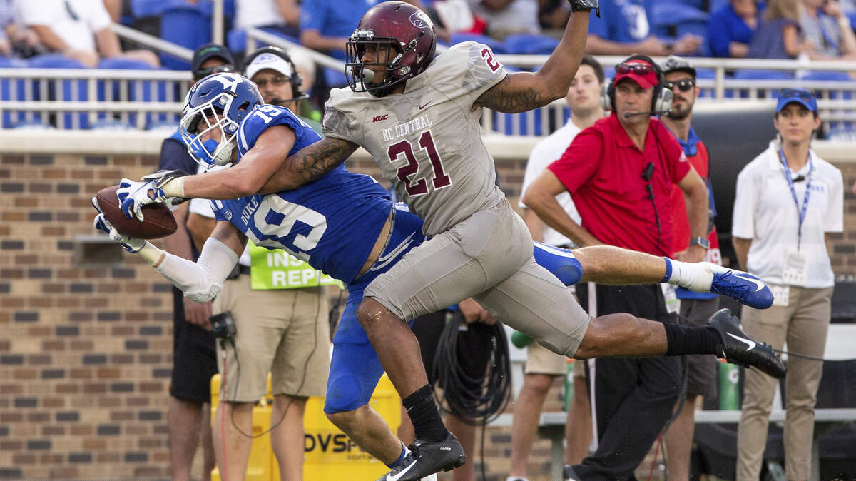 Duke’s Jake Bobo, left, makes a diving catch ahead of N.C. Central’s Daryl Smith, right, during the second half of the Blue Devils’ 55-13 win over the Eagles on Saturay.