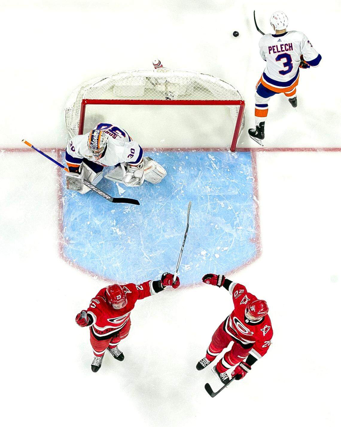 Carolina Hurricanes’ Stefan Noesen (23) and Sebastian Aho (20) react after Noesen scored on New York Islanders’ goalie Ilya Sorokin (30) in the second period on Monday, April 17, 2023 at PNC Arena in Raleigh, N.C.