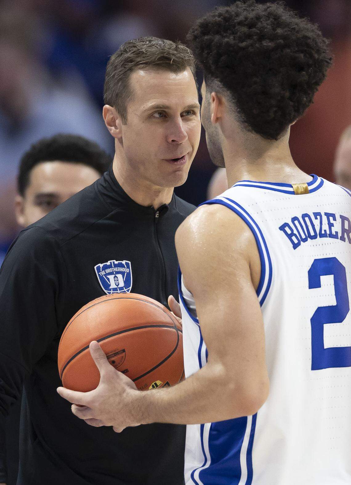 Duke coach Jon Scheyer smiles as he speaks to guard Cayden Boozer (2) as time expires in the Blue Devils’ 73-61 victory over Clemson on Friday, March 13, 2026, during the semifinals of the ACC Tournament at Spectrum Center in Charlotte, N.C.