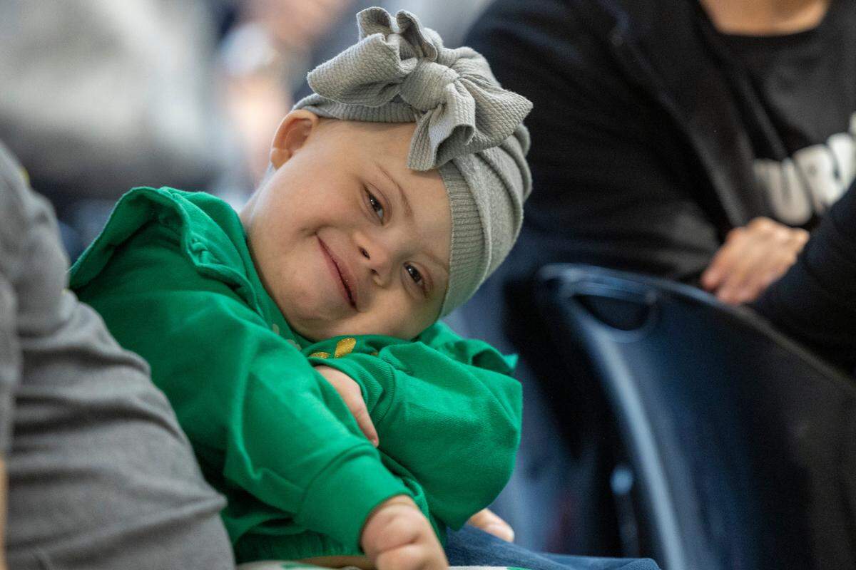 Jurnee Locklear, 3, who has Down syndrome, smiles during a ribbon-cutting ceremony Monday, March 17, 2025, for the opening of UNC Health’s new Down Syndrome Clinic in Chapel Hill. The clinic serves children and adults with developmental disabilities.
