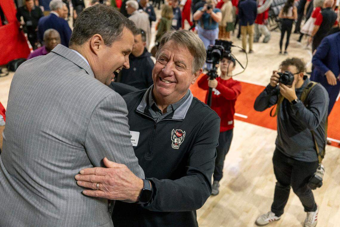 New N.C. State men’s basketball coach Will Wade embraces women’s basketball coach Wes Moore following his introduction on Tuesday, March 25, 2025 at Reynolds Coliseum in Raleigh, N.C.