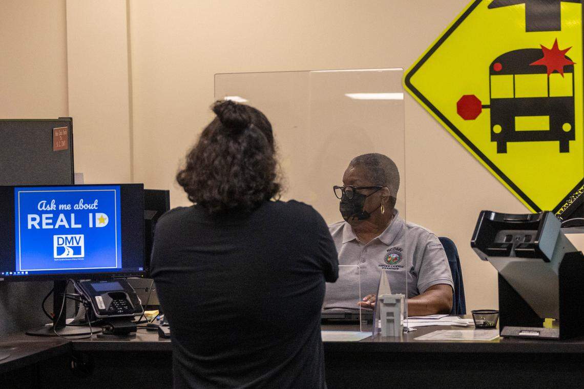 Drivers license examiner Marie Moore helps Bryan Main apply for a drivers license prior to a driving test at the NC Department of Motor Vehicles’ West Raleigh Driver License Office Friday morning, Sept. 2, 2022.