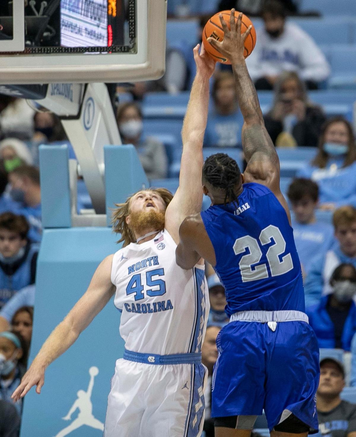 North Carolina’s Brady Manek (45) blocks a shot by Elizabeth City State’s Samuel Sowunmi (22)) during the second half on Friday, November 5, 2021 at the Smith Center in Chapel Hill, N.C.