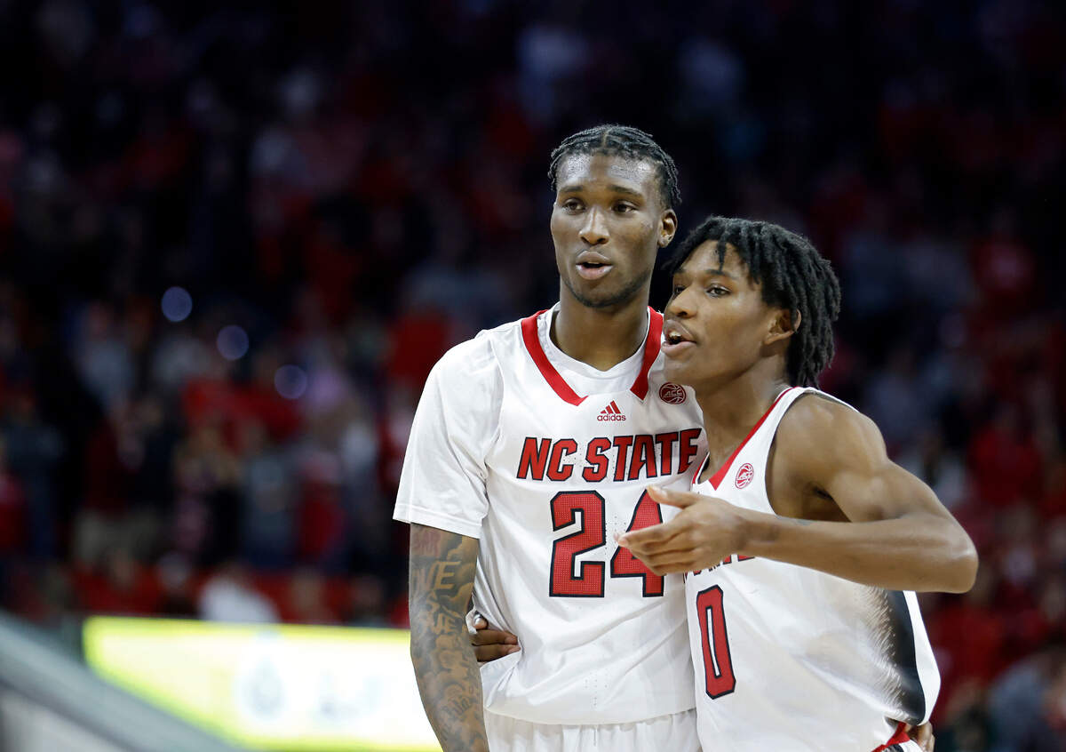 N.C. State’s Ernest Ross and Terquavion Smith have a word during overtime of the Wolfpack’s 83-81 win over Miami at PNC Arena on Saturday, Jan. 14, 2023, in Raleigh, N.C.
