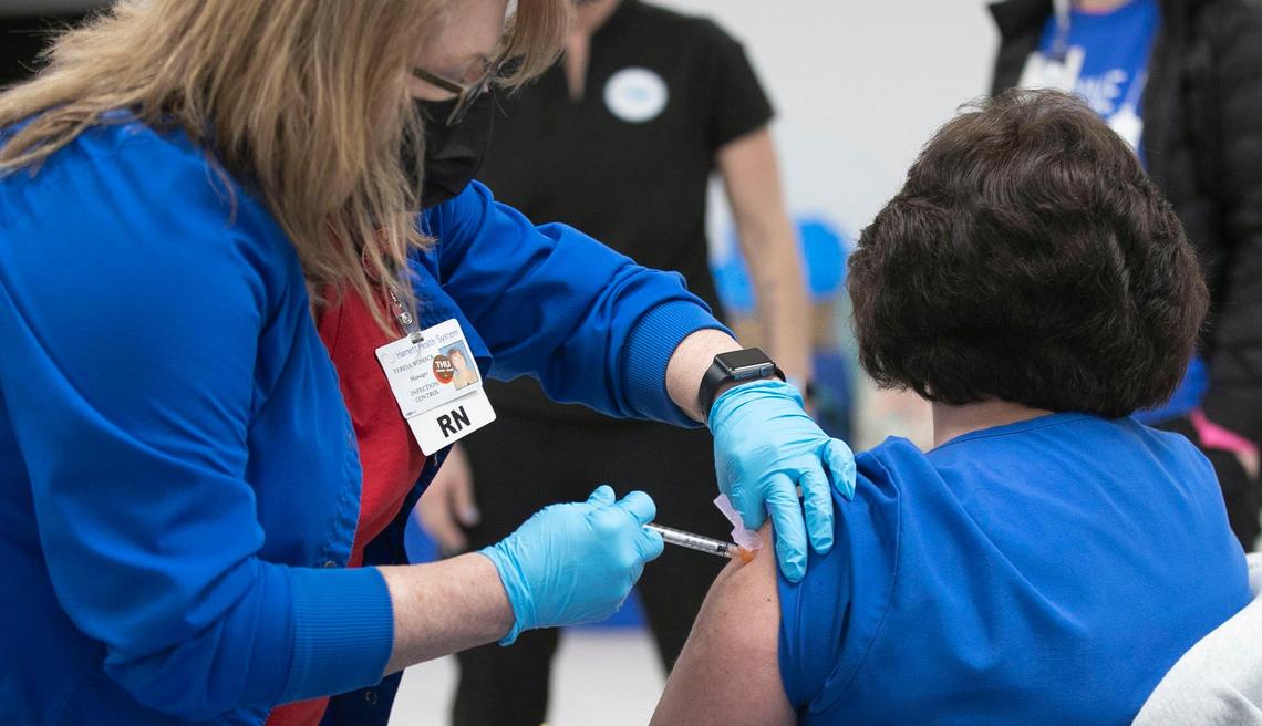 Teresa Womack, RN administers the final dose of the COVID-19 vaccine to Pam Wise, RN at the Dunn Community Center on Friday, February 12, 2021 in Dunn, N.C. Harnett Health administered 1027 doses of the vaccine in four hours on Friday.