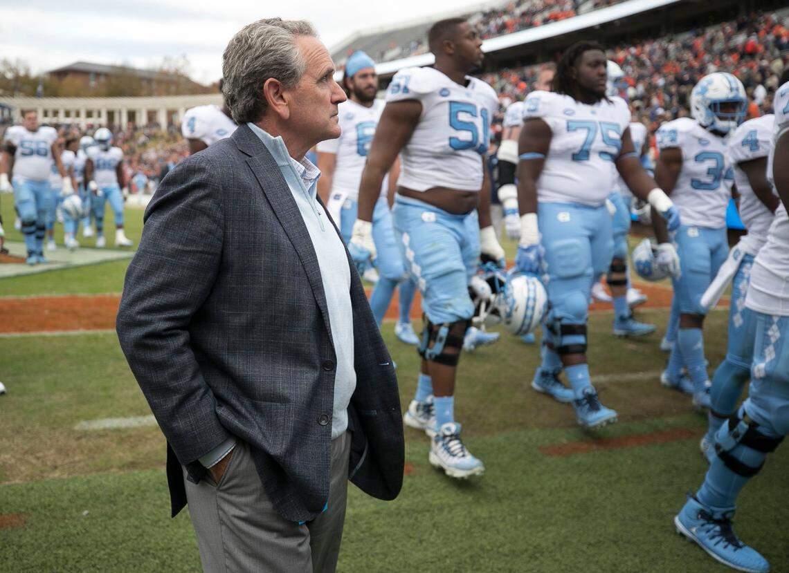 North Carolina athletic director Bubba Cunningham leaves the field with the football team following their 31-21 loss to Virginia on Saturday, October 27, 2018 at Scott Stadium in Charlottesville, Va.