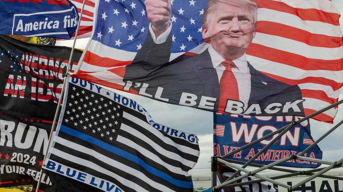 Flags fly outside a rally featuring former President Donald Trump in Selma, NC on Saturday, April 9, 2022.