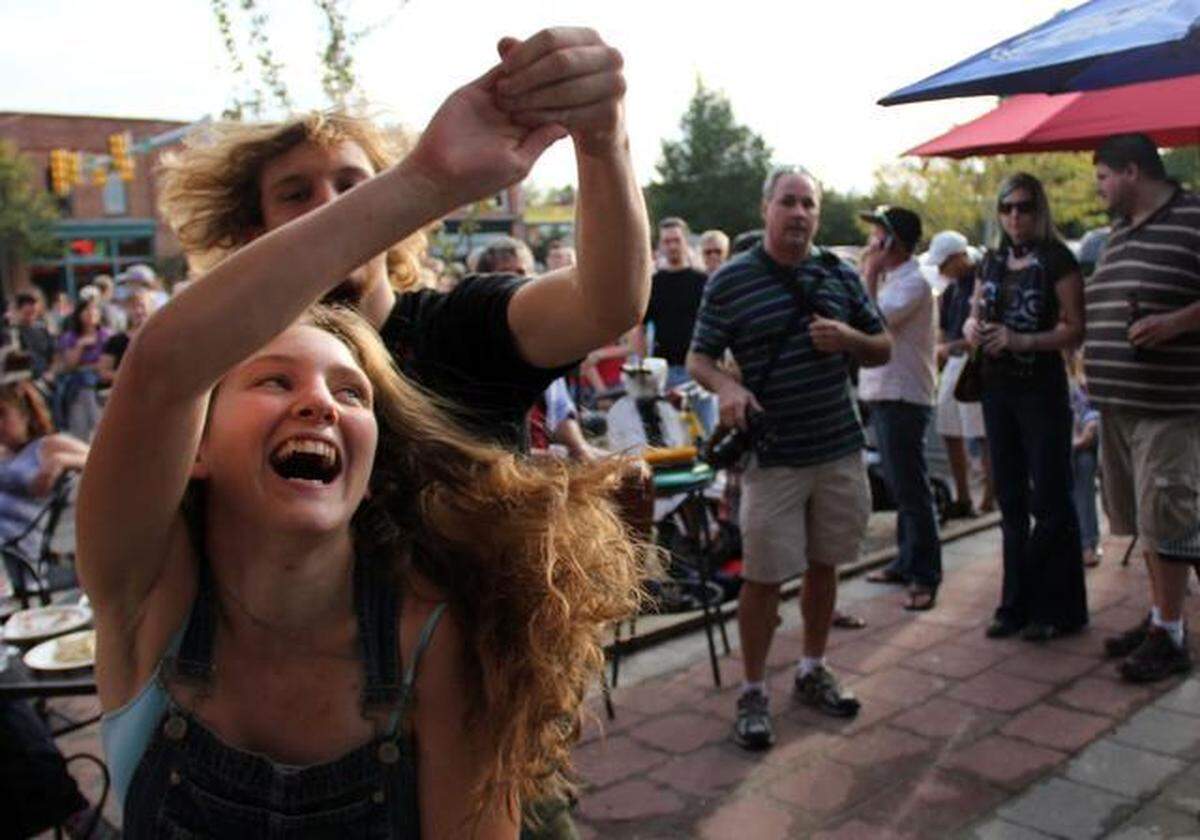 Nicholas, 18, and Ashley Amodei, 17, of Chapel Hill dance to Saints Apollo during the 15th annual Carrboro Music Festival. This year’s festival is scheduled Oct. 2, 2022, though some concerts may be moved indoors or canceled due to heavy rain and winds.